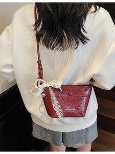 Chic red mini bucket bag with lace bow and pearl charm for casual crossbody style