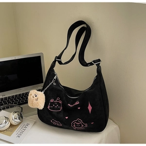Detail of black suede tote bag with pink cat embroidery and plush square keychain