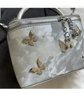 Detailed macro view of silver fabric texture with metal butterfly buckles and heart charms