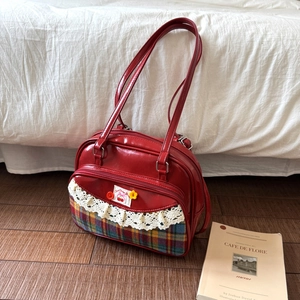 Retro red bowling bag with cherry embroidery and lace detail in a minimalist style