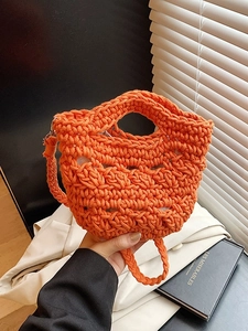 Vibrant orange handmade crochet bucket bag with a stylish hollow knit pattern for women