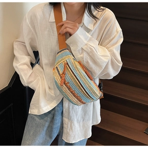 Detail of bohemian colorful striped woven crossbody bag with embroidery and wide strap