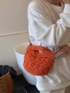 Handmade orange knitted bucket bag for women with woven texture for summer beach vacation