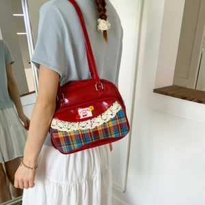 Red plaid tote bag with cherry patch and lace trim shown being worn on the shoulder