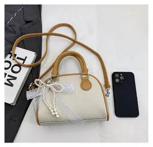 Litchi pattern Boston bag size comparison next to a phone and professional accessories