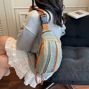 Handwoven straw shoulder bag with colorful stripes and adjustable brown strap