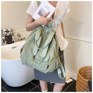 Close-up of lightweight green backpack with multiple pockets and durable nylon texture