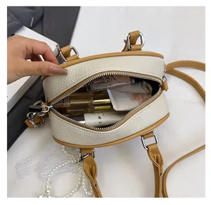 Internal view of litchi leather bag showing spacious storage for cosmetics and essentials