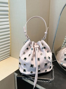 Pink studded bucket bag with silver metal chain strap and drawstring closure