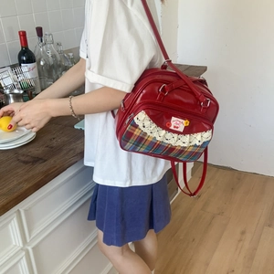 Close-up of red retro tote with lace and cherry patch in a lifestyle kitchen scene