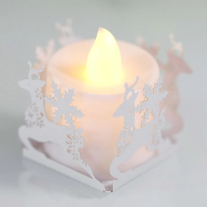 Close-up of reindeer and snowflake laser-cut paper lantern with warm LED candle light