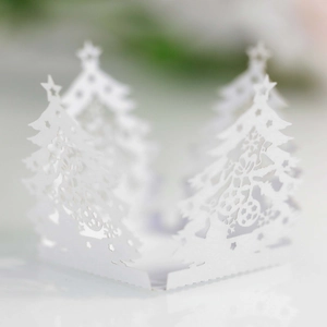 Detailed close-up of white laser-cut Christmas tree paper lantern with snowflake patterns