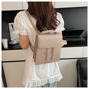 Detailed view of the chic cream PU leather backpack featuring chain and zipper details