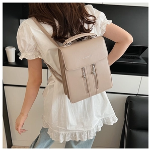Detail of beige faux leather backpack with Fashion & Bags embossing and twin vertical zippers