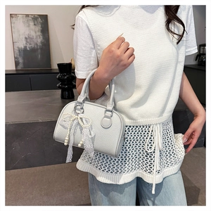 Detail of light blue lychee pattern Boston bag with lace bow and pearl pendant
