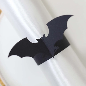 Macro shot of Halloween black bat napkin ring crafted from laser-cut cardstock paper