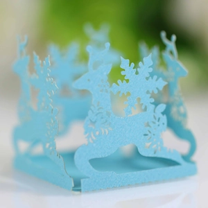 Detail of light blue laser-cut paper lampshade with reindeer and snowflake motifs