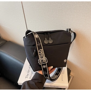 Detail of black nylon crossbody bag with jacquard SJCHAO wide strap and dual zippers