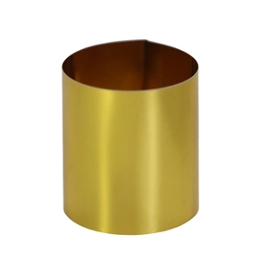 Detail of a polished gold metal napkin ring with a sleek minimalist cylindrical design