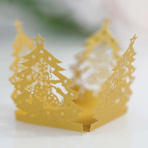 Detailed laser-cut Christmas tree golden cupcake wrapper with star and bell motifs