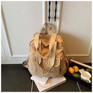Khaki nylon travel backpack featuring multiple zipper pockets and wide shoulder straps