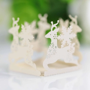 Detailed laser-cut Christmas cupcake wrapper with reindeer and snowflake patterns