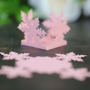 Detailed view of pink snowflake hollow paper cutout for Christmas party decorations
