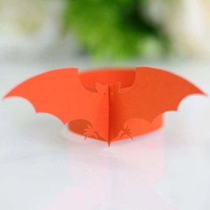 Macro detail of an orange bat paper napkin ring for festive Halloween table decor
