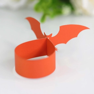 Macro view of orange paper bat napkin ring for Halloween party table decoration