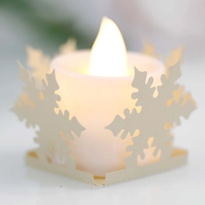 Close-up of LED electronic candle with hollow snowflake pattern laser-cut paper lampshade