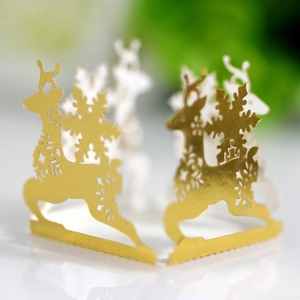 Detailed macro view of laser-cut gold reindeer and snowflake Christmas decoration