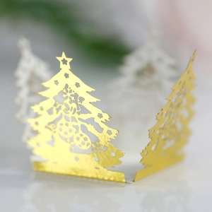 Macro detail of gold laser-cut hollow Christmas tree lantern with star patterns