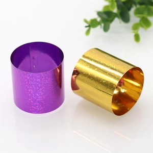 Detail view of purple and golden glitter napkin rings with holographic finish texture