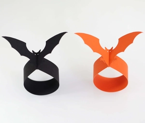 Detail of laser-cut black and orange bat napkin rings for Halloween table decor