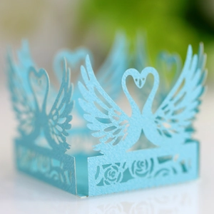 Detail of light blue laser-cut swan heart paper decorative border for weddings and parties