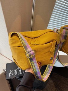 Casual yellow canvas crossbody bag with wide colorful strap and multi-zipper pockets