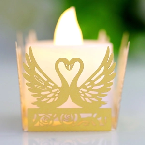 Close-up of laser-cut swan heart candle holder with romantic hollow rose pattern detail