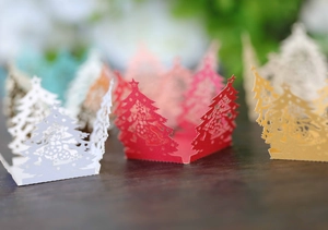 Detailed laser-cut Christmas tree paper lamp shades in red, gold, and white colors