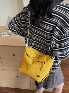 Ginger yellow canvas crossbody bag with vibrant colorful striped wide shoulder strap