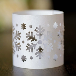 Macro shot of laser-cut white snowflake napkin rings for Christmas party table decor