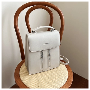 Detail of cream faux leather backpack with vertical zippers and litchi texture