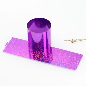 Detail of purple holographic napkin ring with sparkling glitter finish for hotel dining decor