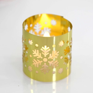 Detail of golden hollow snowflake metal lampshade with warm LED light for Christmas