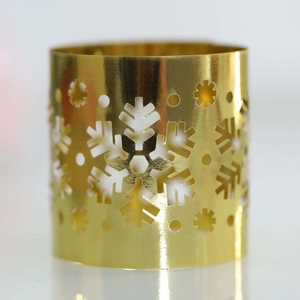 Macro shot of gold snowflake cutout napkin ring with metallic mirror finish for Christmas