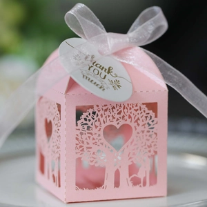 Detail of pink laser-cut tree candy box with white ribbon and Thank You hangtag