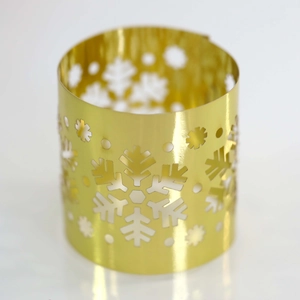 Detailed close-up of golden snowflake hollow design napkin ring with metallic texture