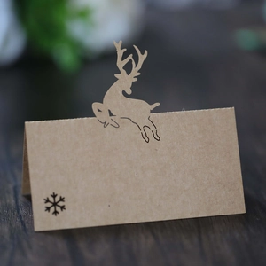 Detailed view of hollow reindeer and snowflake design on kraft paper place cards