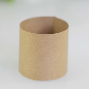 Close-up of a brown kraft paper napkin ring with a cylindrical minimalist texture