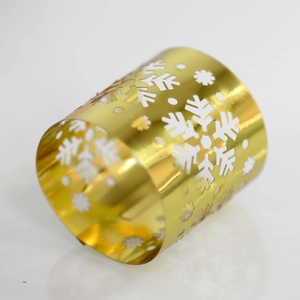 Detailed macro view of a silver mirror-finish napkin ring with hollow snowflake patterns