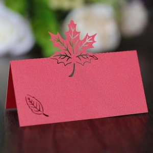 Laser cut red maple leaf place cards with pearlescent finish for autumn wedding table decor